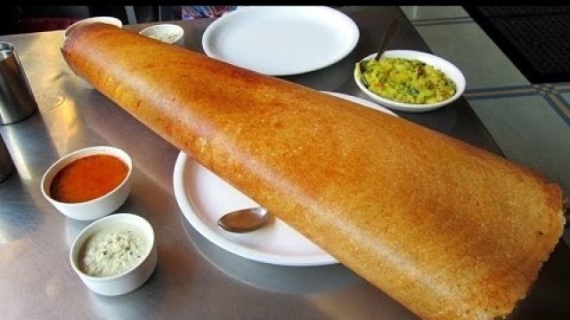 'PAPER DOSA, INDIAN FOOD, HUGE PAPER DOSA MADE IN AN INDIAN FOOD RESTAURANT'