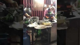 'Thai Street Food. Chef cooking skills Bangkok Chinatown Yaowarat Thailand. Fried noodles gravy sauce'