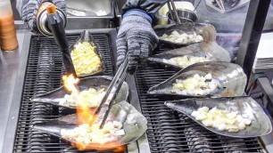 'Baked Scollops with Melted Cheese. Korea Street Food in Myeongdong, Seoul'