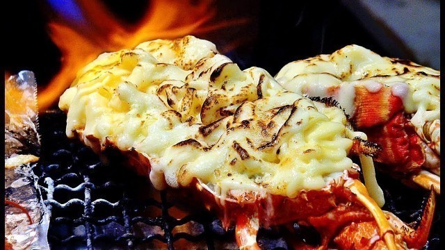 'GRILLED LOBSTER WITH CHEESE Japanese street food at Kuromon market Osaka'