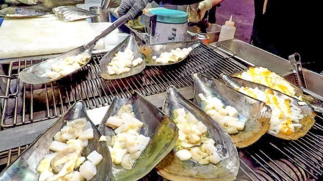 'Cheese Butter Baked Scallops. Korea Street Food in Myeongdong, Seoul'