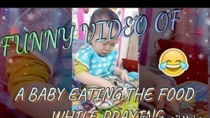 'Baby Eating the Food while Praying'